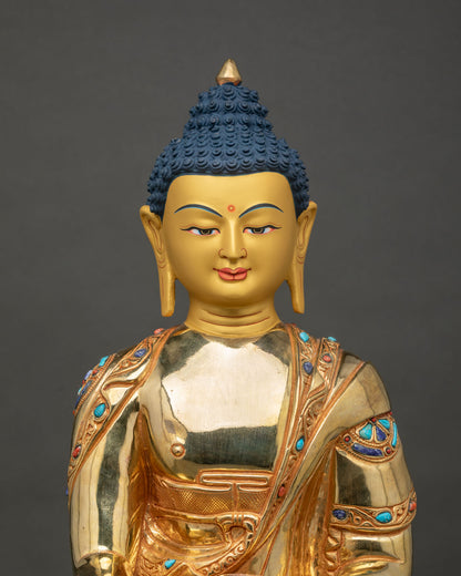 Shakyamuni Buddha statue 24k gold painted face turquoise lapis coral close up.