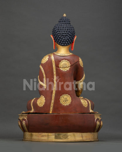 Shakyamuni Buddha statue back view, gilded robe with lotus medallion details
