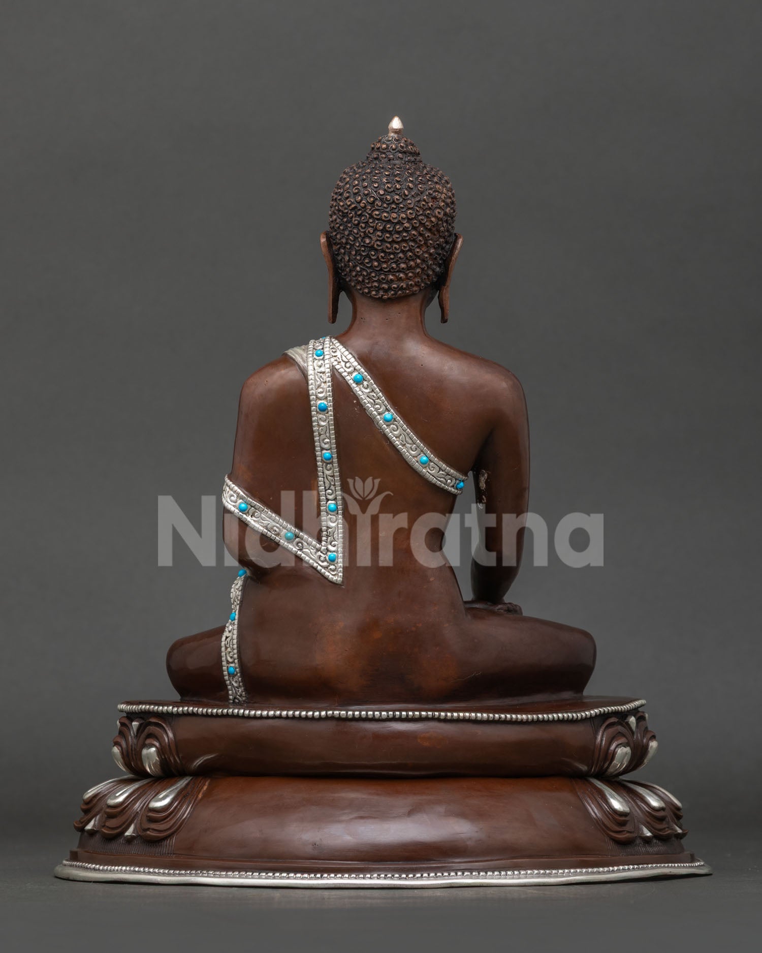 Shakyamuni buddha statue back view showing lotus pedestal and detailed handcrafted robe.