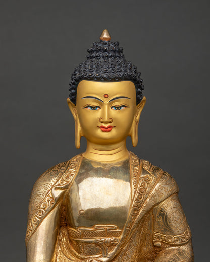 Shakyamuni Buddha statue close up 24k gold painted face and floral robe.
