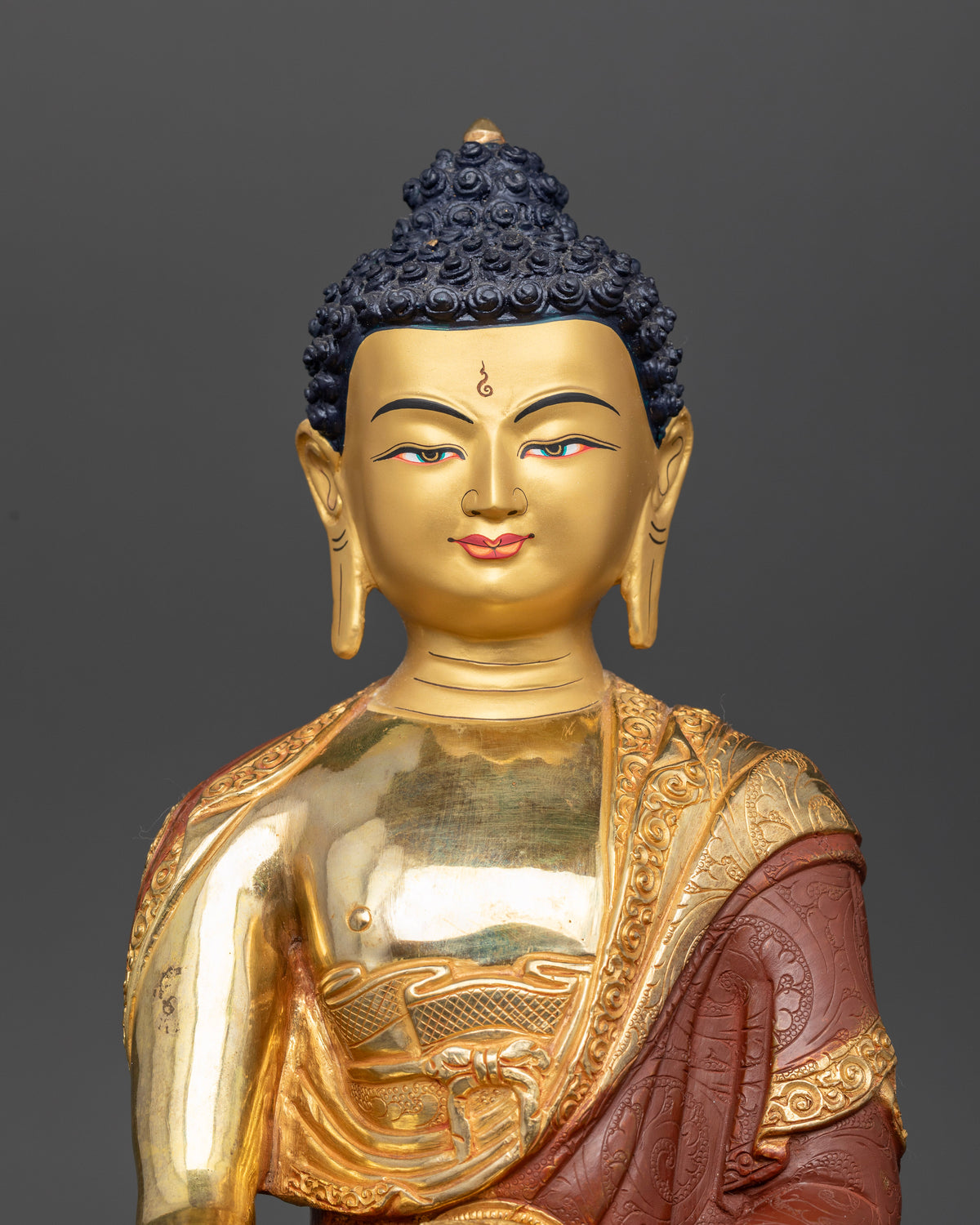 Shakyamuni Buddha Statue close up 24K gold painted face Newari craftsmanship.