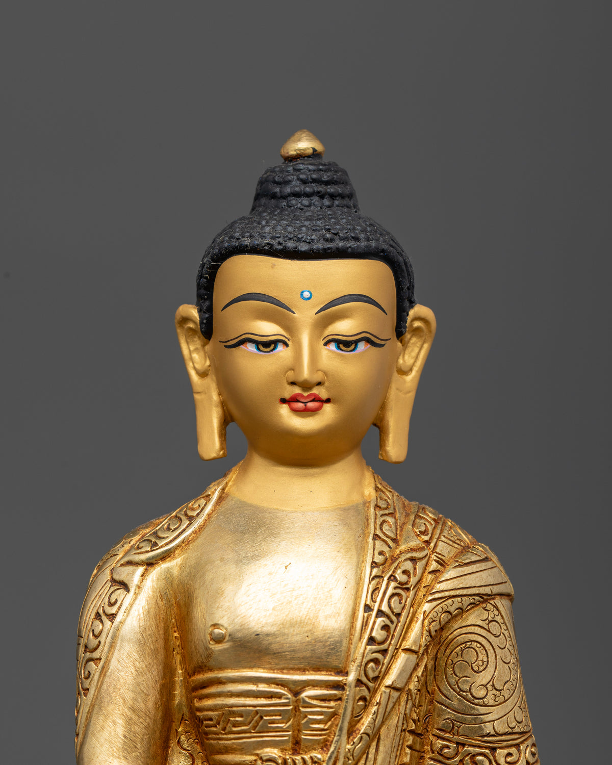 Shakyamuni Buddha Statue Close Up 24K Gold Painted Face.
