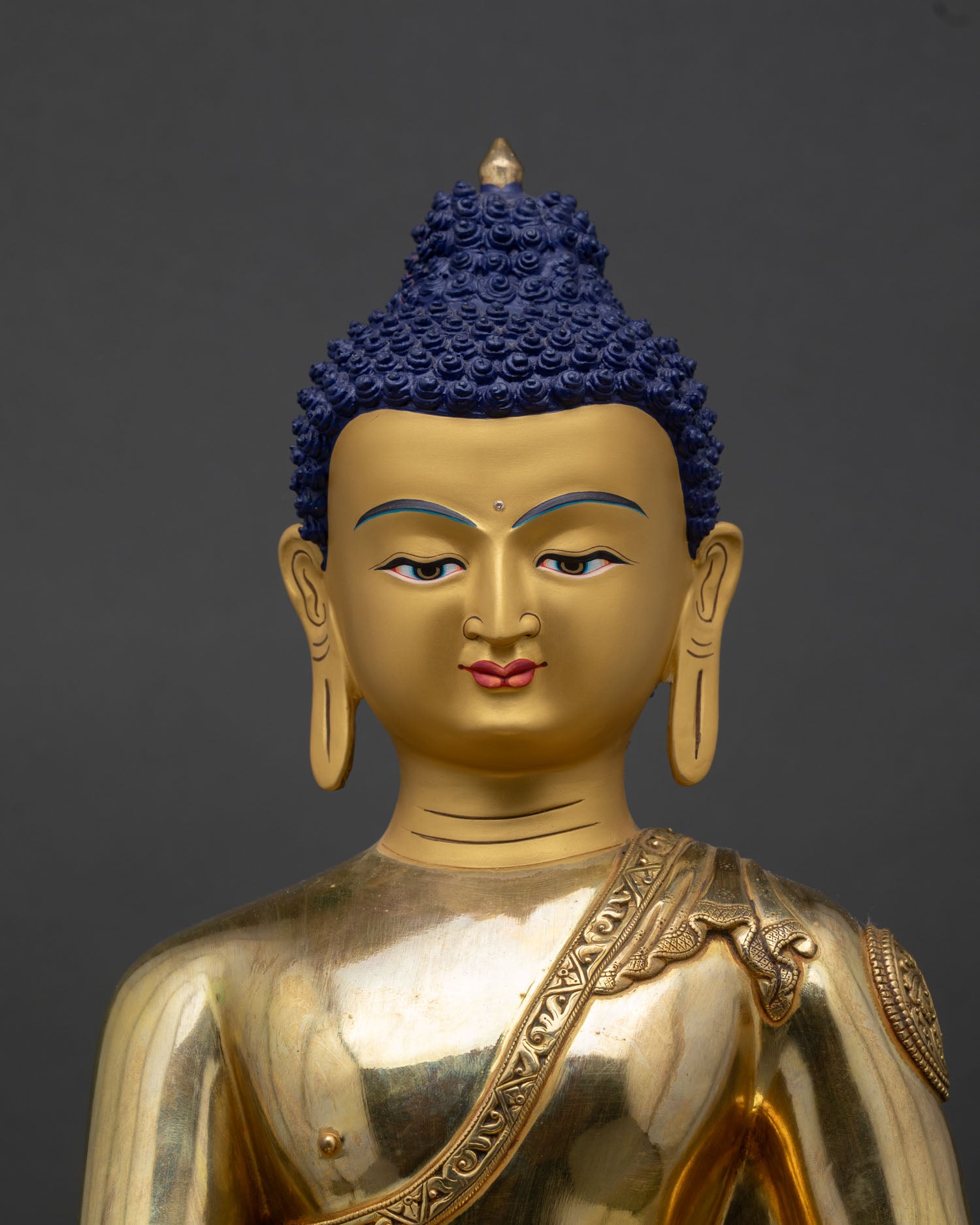 Shakyamuni Buddha statue close-up copper robes lotus seat fire-gilded gold details Nepal