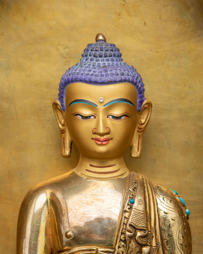 Shakyamuni Buddha statue close-up showing fire gilded gold and torana details