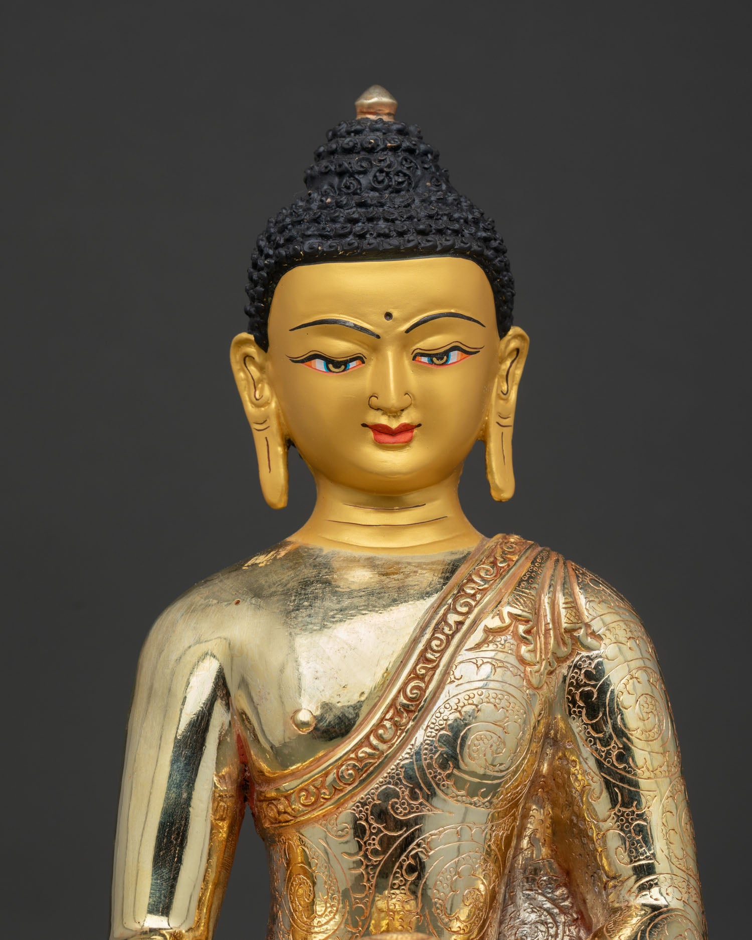Shakyamuni Buddha Statue Close Up Gold Painted Face and Floral Motif Monk Robe.