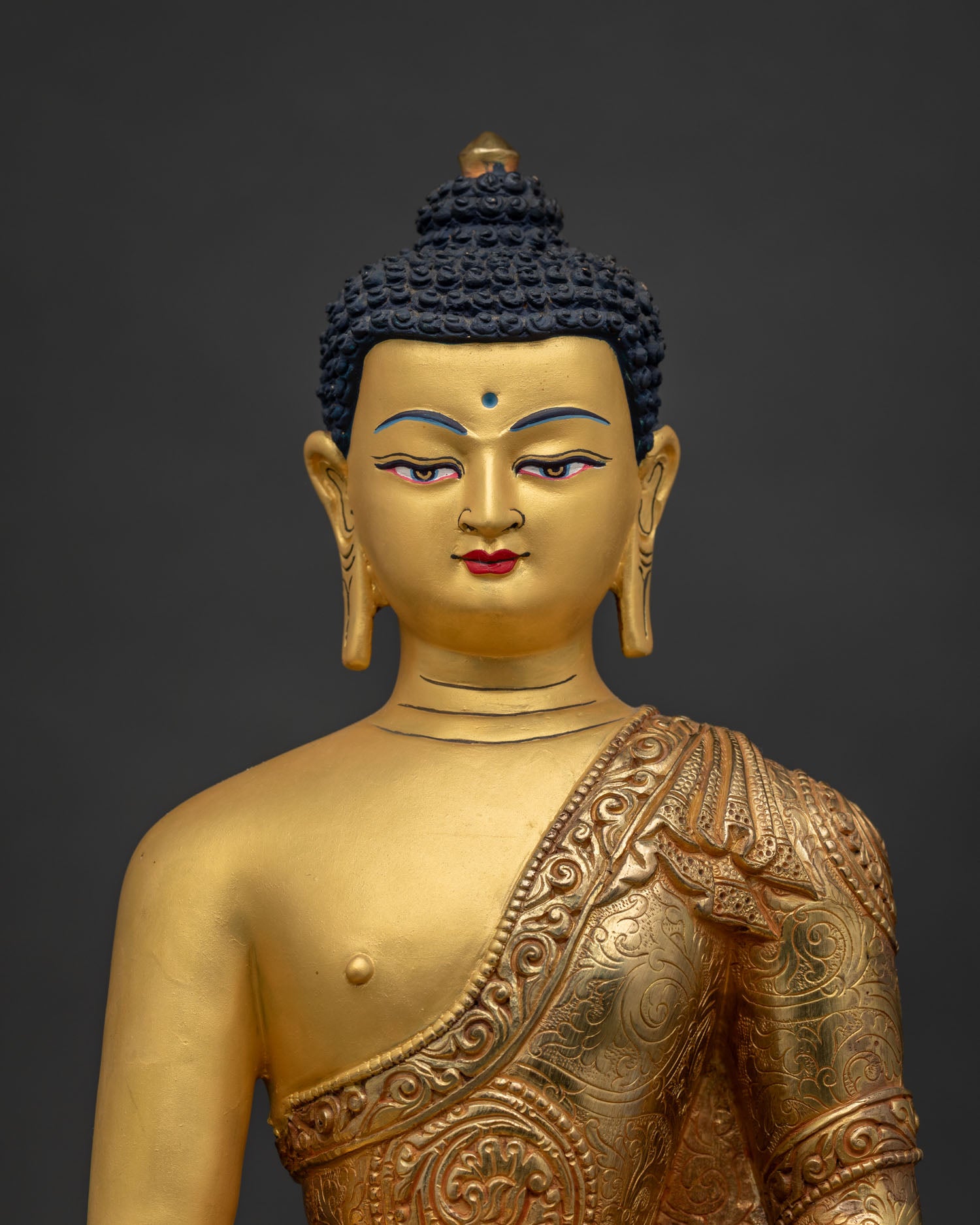 Shakyamuni Buddha Statue Close Up Gold Painted Face and Floral Motif Robe.