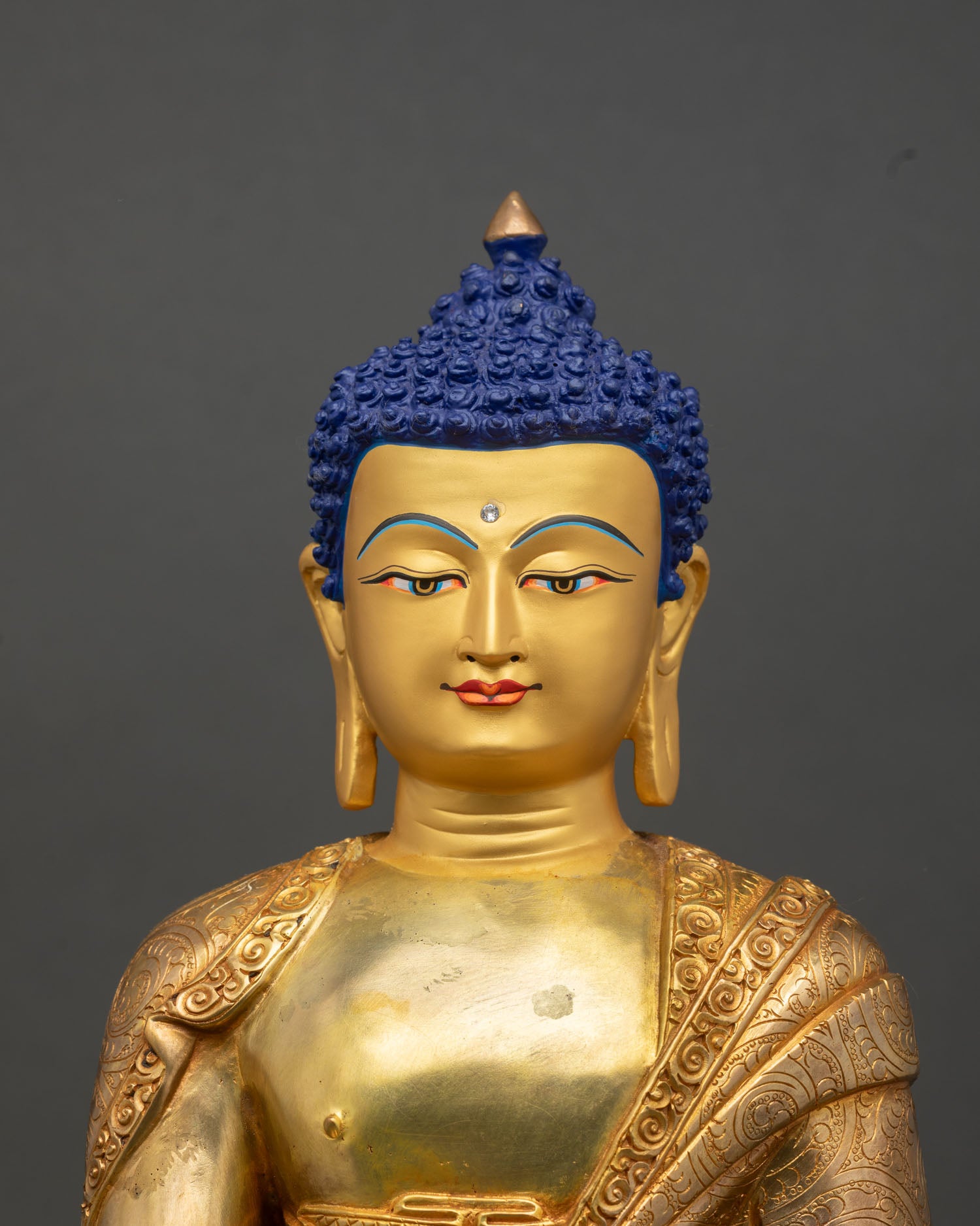 Shakyamuni Buddha statue close up gold painted face inlay detailed Himalayan craftsmanship spiritual sculpture