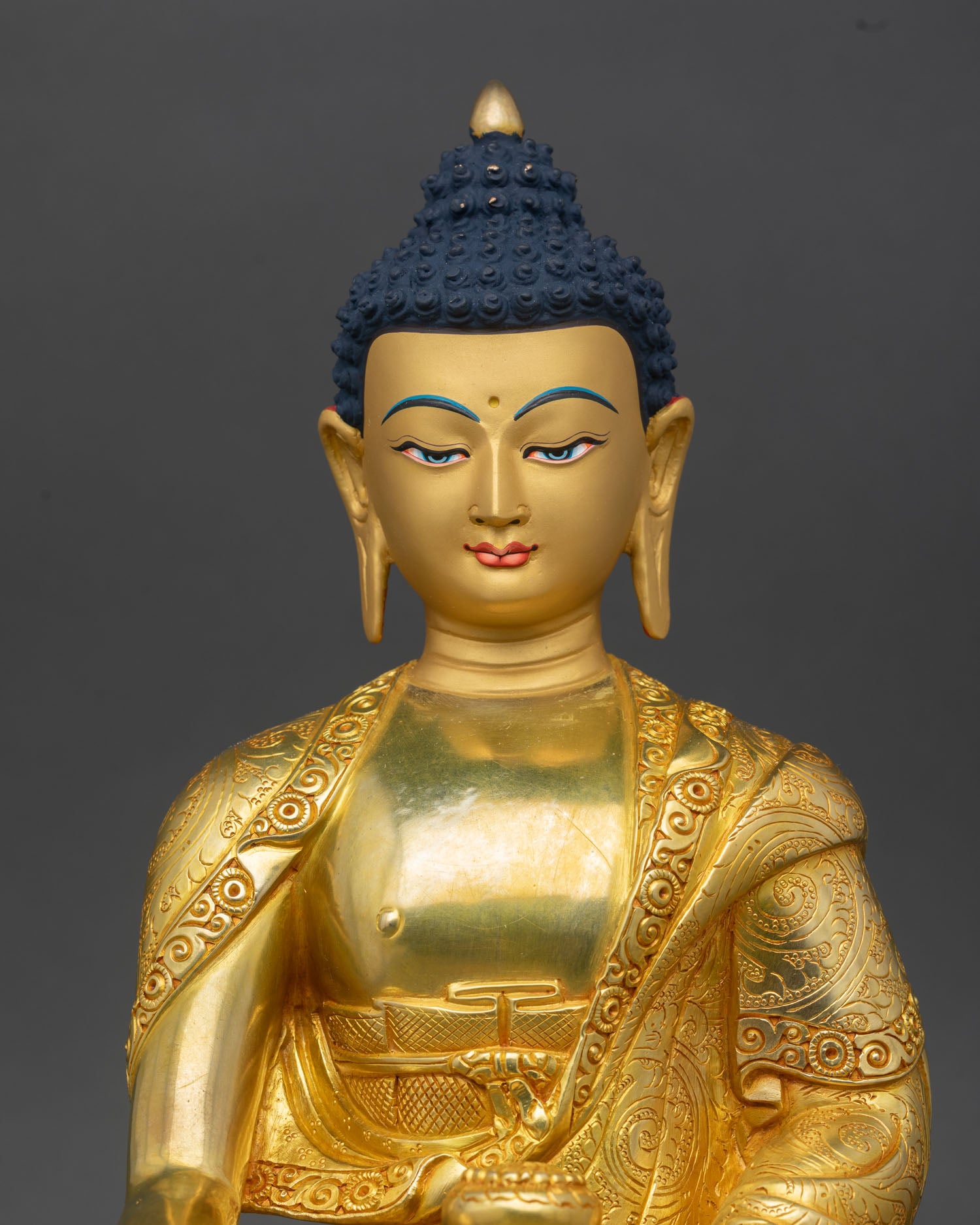 shakyamuni bauddha statue close up, handcrafted nepalese copper with gold gilding details