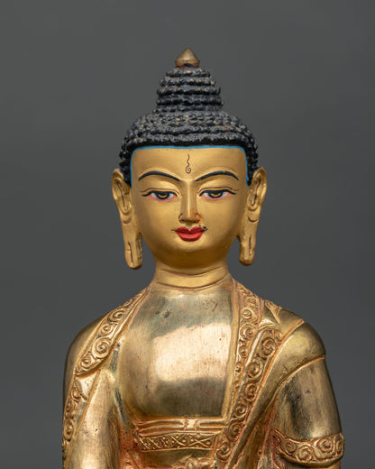 Shakyamuni Buddha statue close-up showing 24k gold painted face and serene expression.