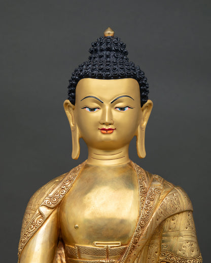 Shakyamuni Buddha statue close up showing gold gilded details and serene expression