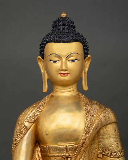 Shakyamuni Buddha statue close-up with gold-painted face and serene enlightened expression