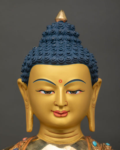Shakyamuni Buddha statue deep blue eyes elongated ears face close up.