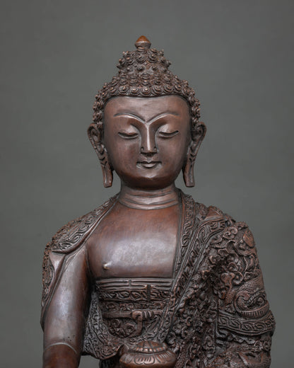Shakyamuni Buddha statue featuring a finely detailed face and with a traditional chemically oxidized finish.