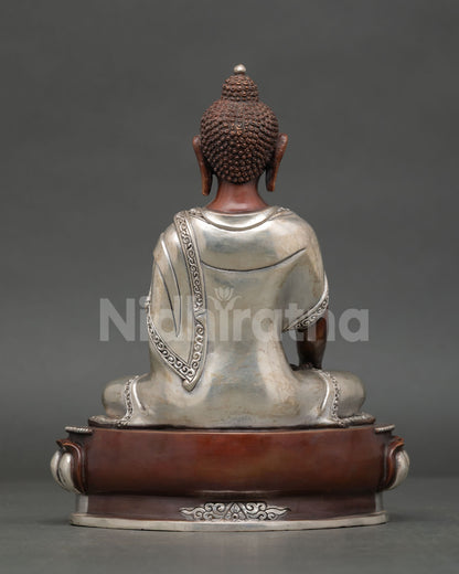 Shakyamuni buddha statue displaying intricate silver plated copper artwork and buddhist design.