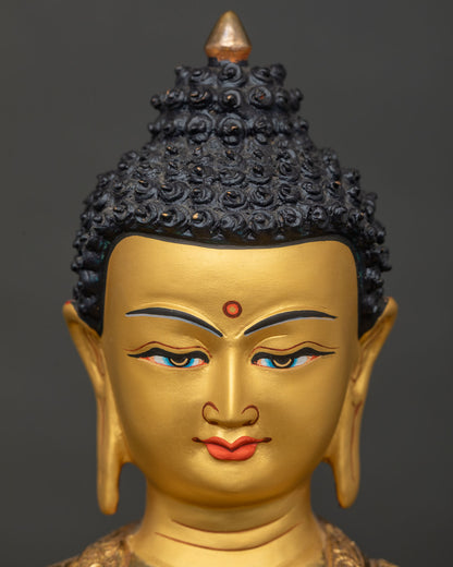 Shakyamuni Buddha statue face close up serene expression 24k gold painted face.