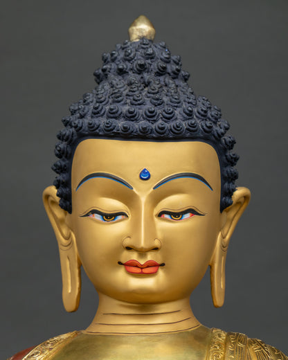Shakyamuni Buddha statue face close-up, serene gold-painted meditative expression