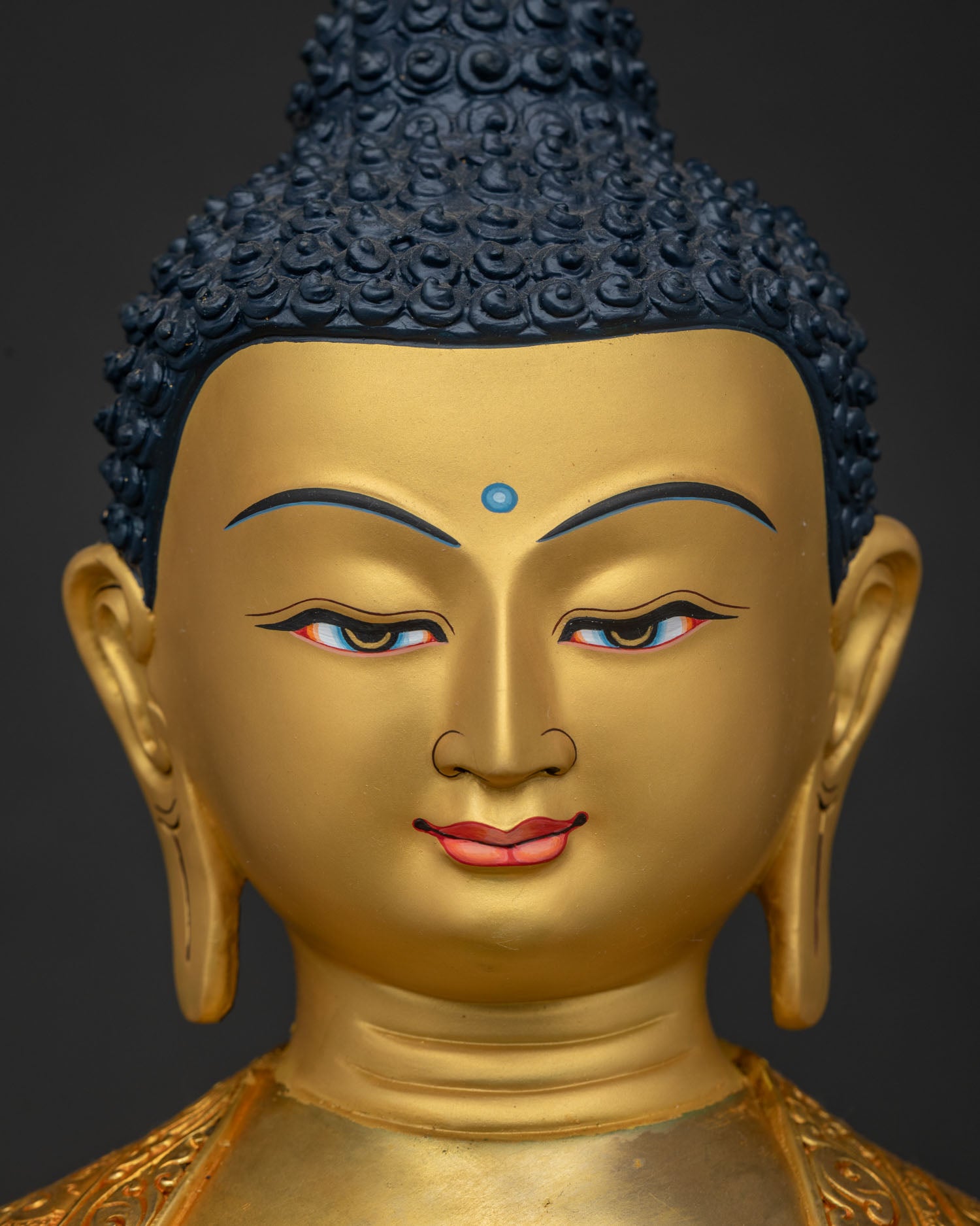 Shakyamuni Buddha Statue Face Close Up with 24K Gold Painted Serene Expression