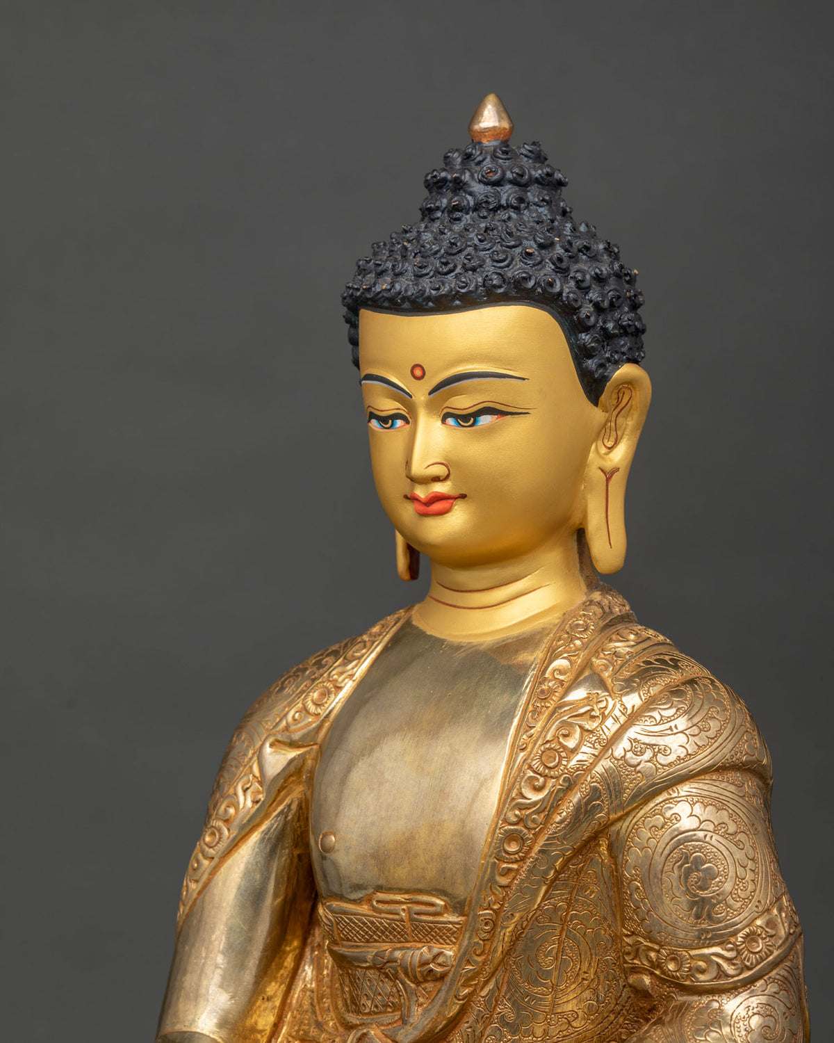 Shakyamuni Buddha statue face close up with earth touching mudra and begging bowl.