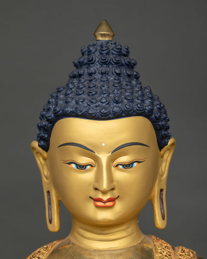 Shakyamuni Buddha statue face close-up with serene hand-painted expression and blue curled hair