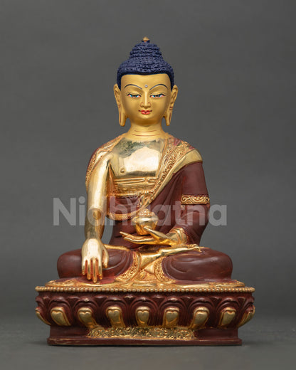 Shakyamuni Buddha statue front view, copper body with gold fire gilding, patra bowl in lap, Nepal