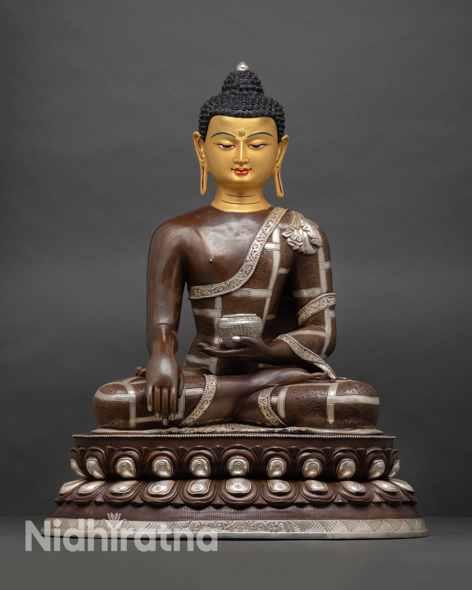 Shakyamuni Buddha statue, front view, double lotus throne, copper sculpture, gold-painted face, oxidized silver finish nepal