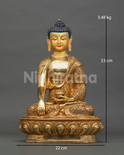 Shakyamuni Buddha statue gold fire gilded copper Patan Nepal.