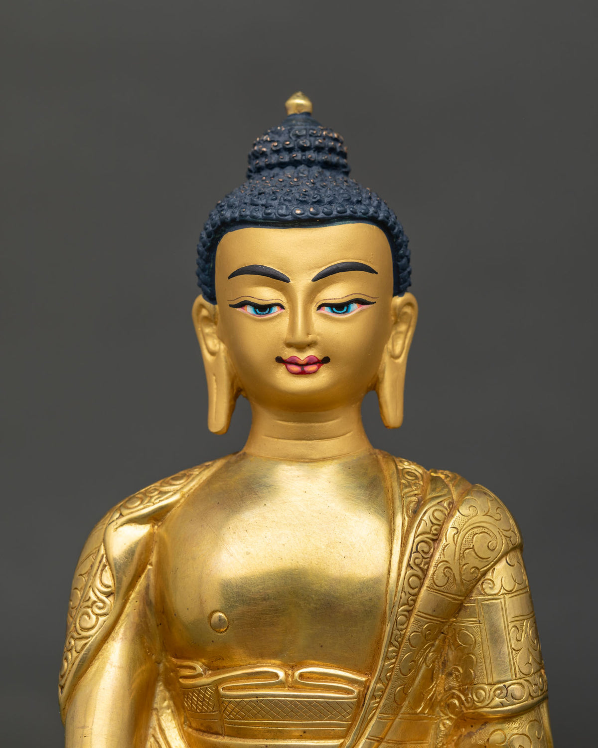 shakyamuni buddha statue gold fire gilded nepalese buddhist art close up