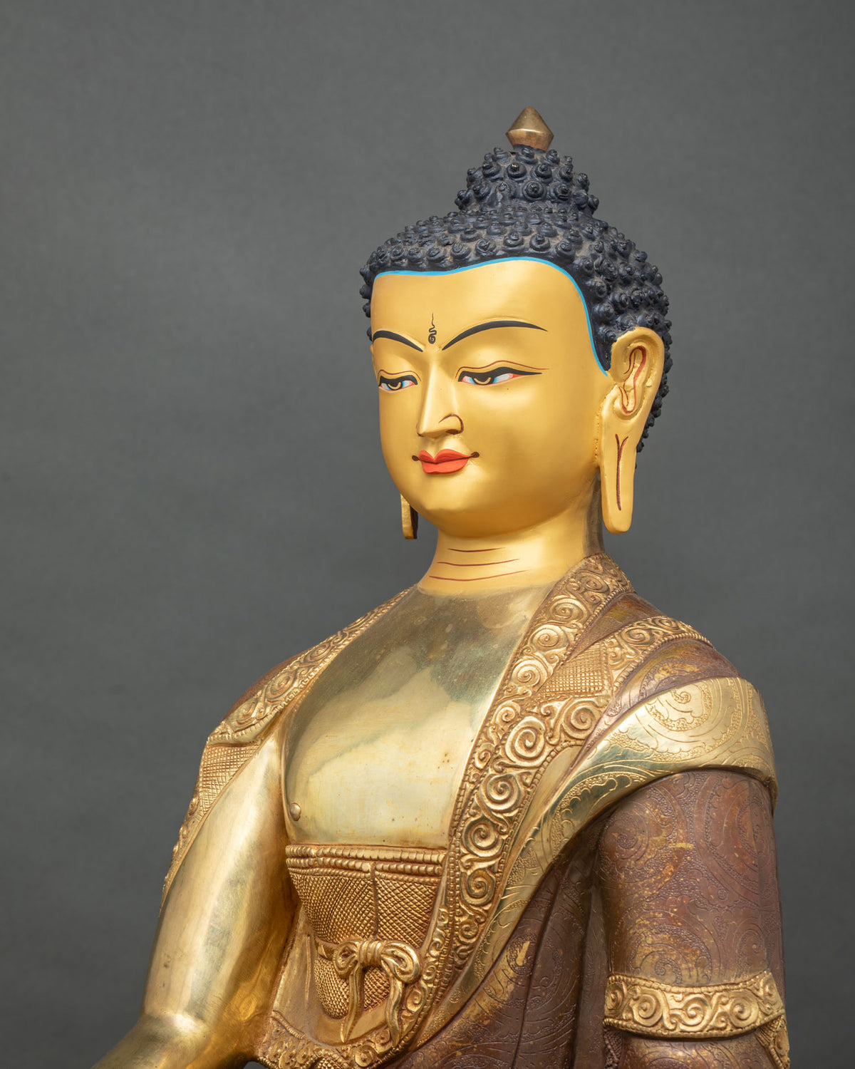 Shakyamuni Buddha statue on a hand carved double lotus pedestal with gold fire gilded finish.