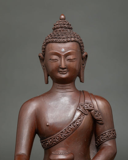 Shakyamuni Buddha statue seated on a hand carved lotus pedestal wearing an intricately carved monk's robe.
