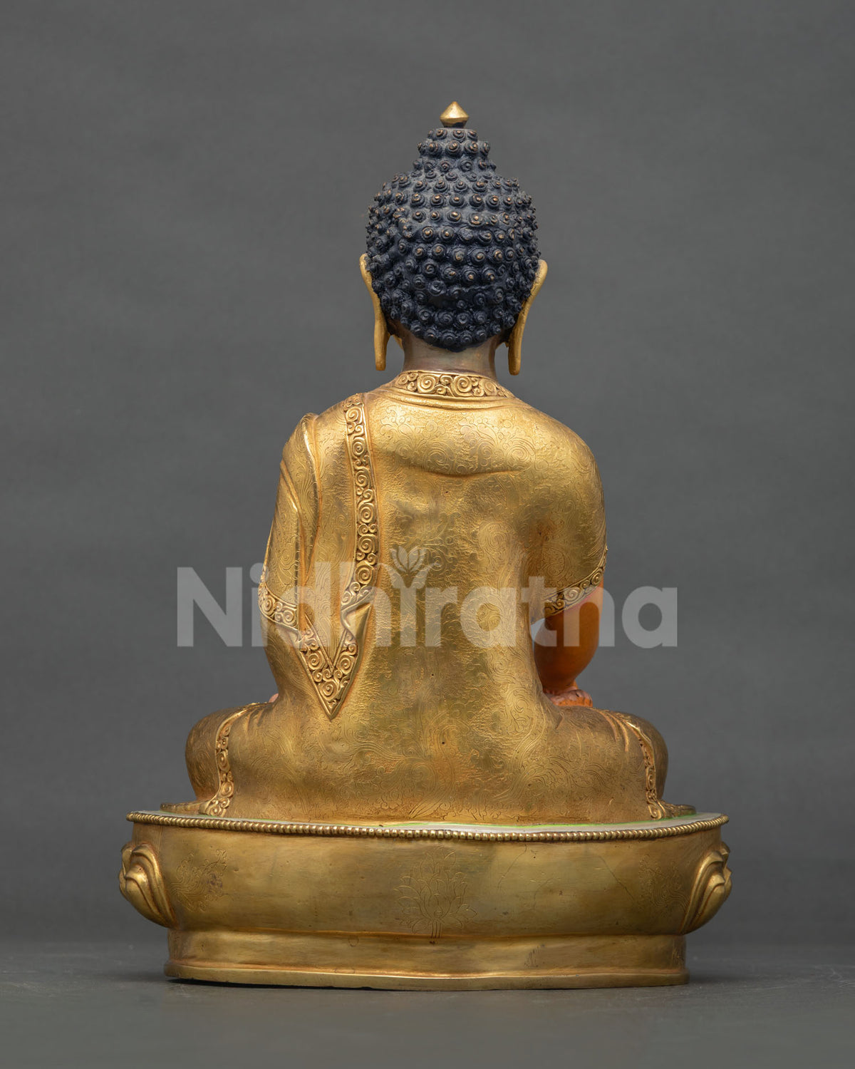 Shakyamuni Buddha statue seated on a hand carved lotus pedestal crafted by a skilled Newari artist from Nepal.