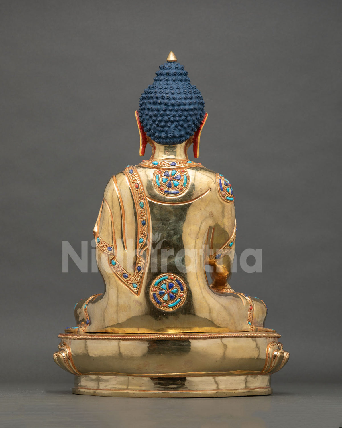 Shakyamuni Buddha statue hand carved monk robe lotus throne back view.