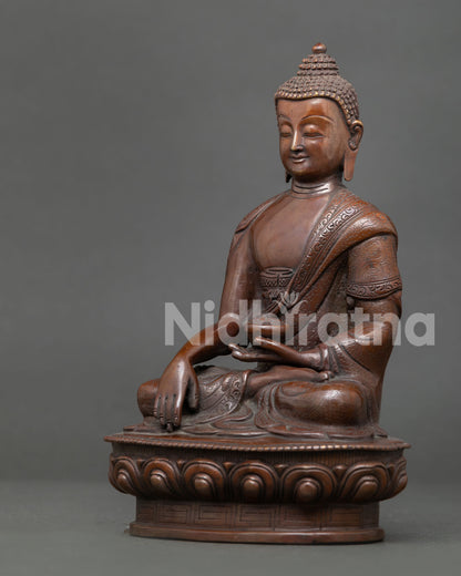 Shakyamuni Buddha statue handcrafted by Newari artisan from Patan Nepal with oxidized copper finish and Himalayan Buddhist craftsmanship.