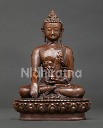 Shakyamuni Buddha statue handcrafted in Nepal from copper with oxidized finish seated on lotus throne.