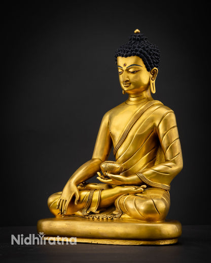Shakyamuni Buddha statue handcrafted in Nepal with 24K gold fire gilded copper finish flowing monastic robes and meditation posture on pedestal