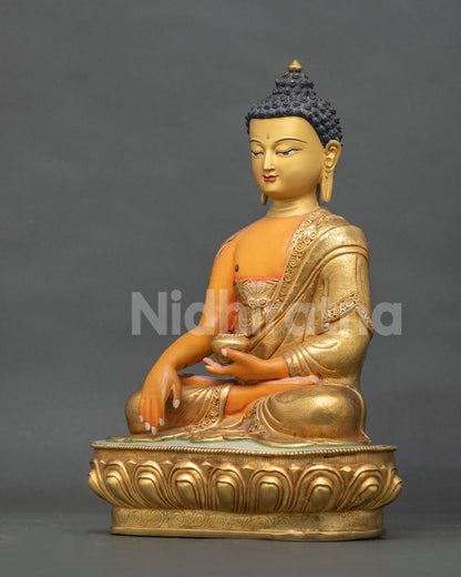 Shakyamuni Buddha statue holding a traditional begging bowl representing simplicity and renunciation in Buddhist teachings.