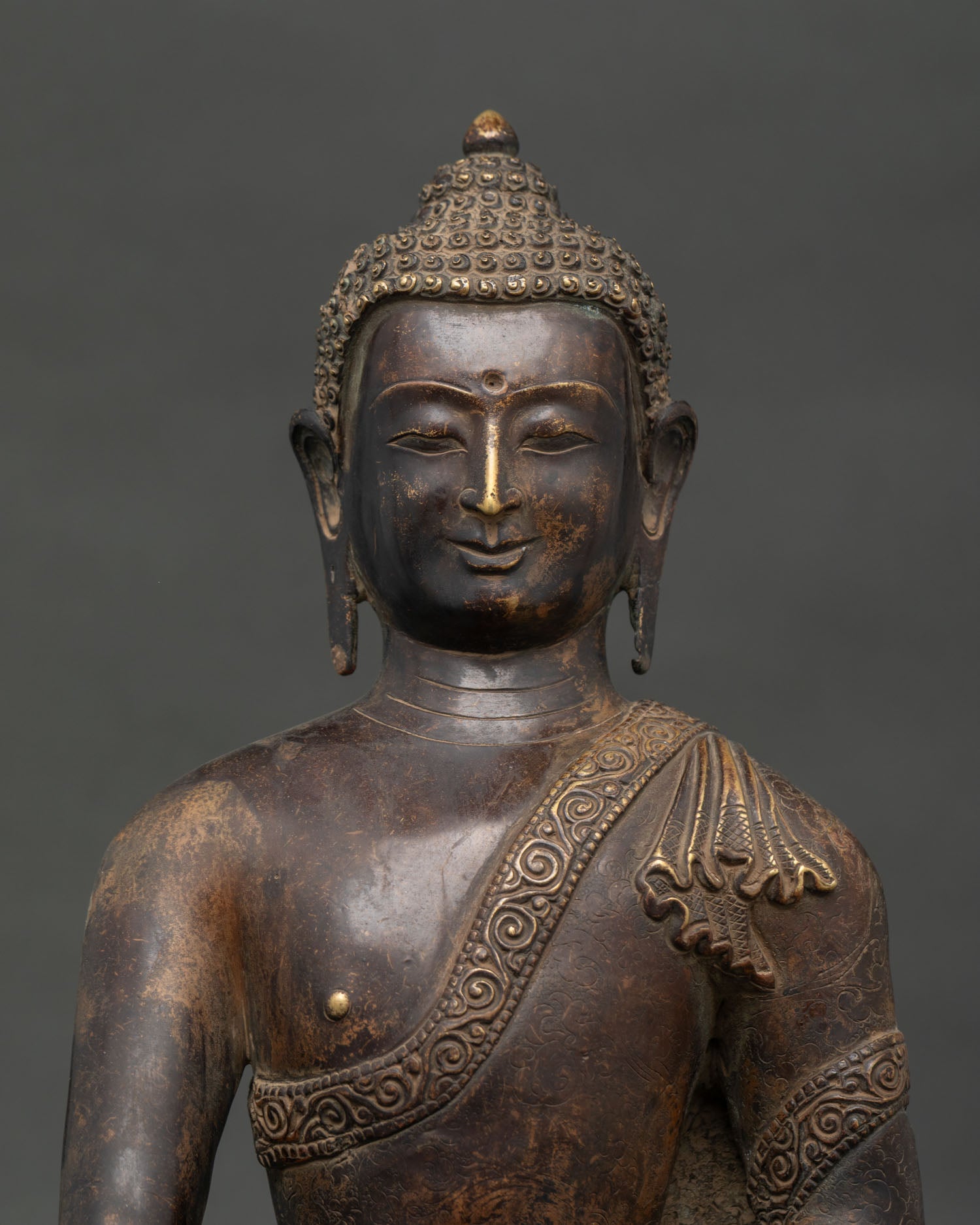 Shakyamuni Buddha statue holding traditional monk begging bowl with serene expression.