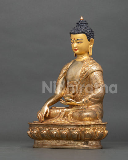 Shakyamuni Buddha statue left side view with lotus pedestal and monastic robe.