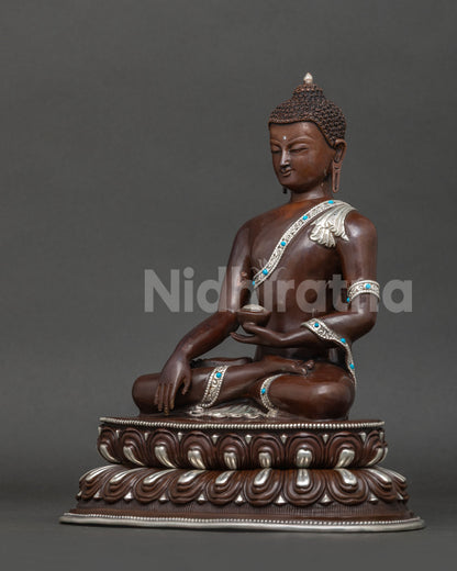 Shakyamuni buddha statue left view showing double lotus pedestal and silver plated details.