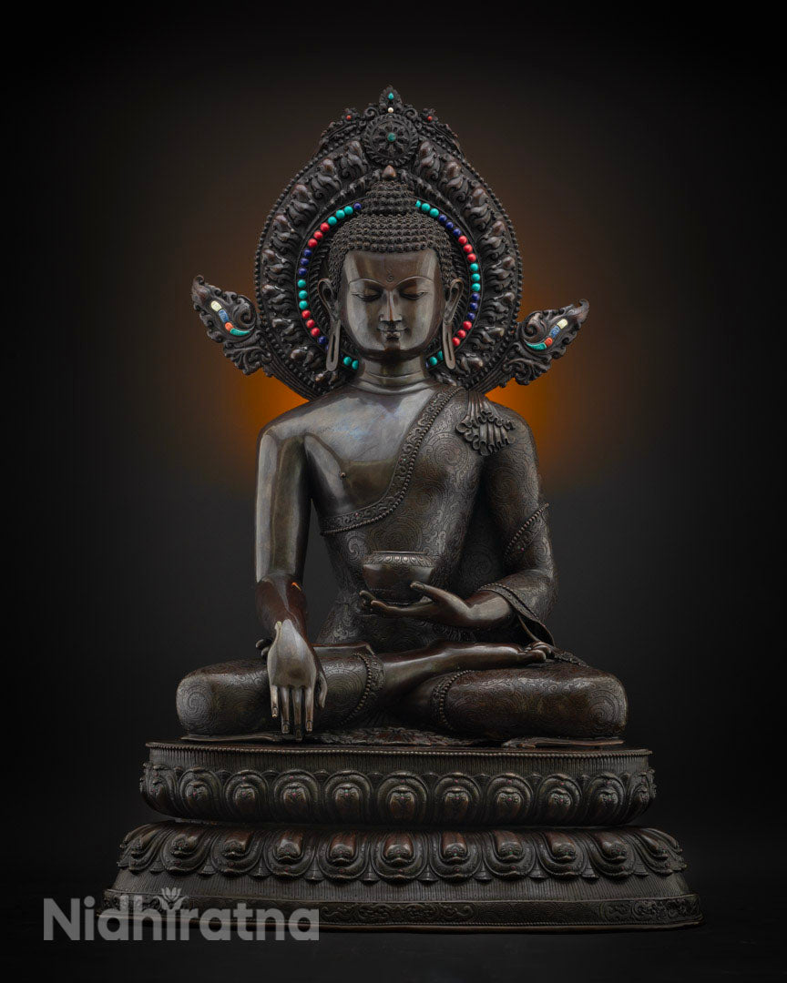 Shakyamuni Buddha statue in oxidized copper, front view with turquoise inlay