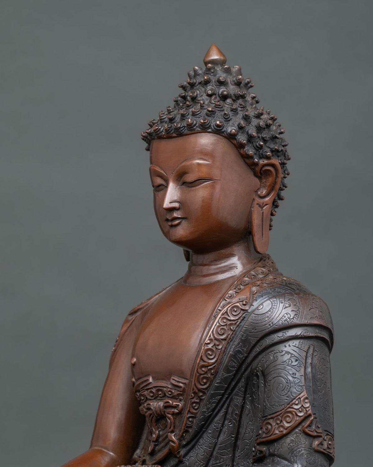 Shakyamuni Buddha statue with oxidized copper patina and traditional Nepalese craftsmanship.