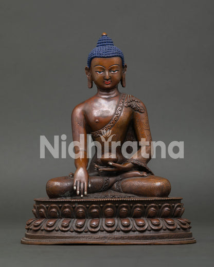 Shakyamuni Buddha statue seated on double lotus pedestal with oxidized copper finish from Nepal.