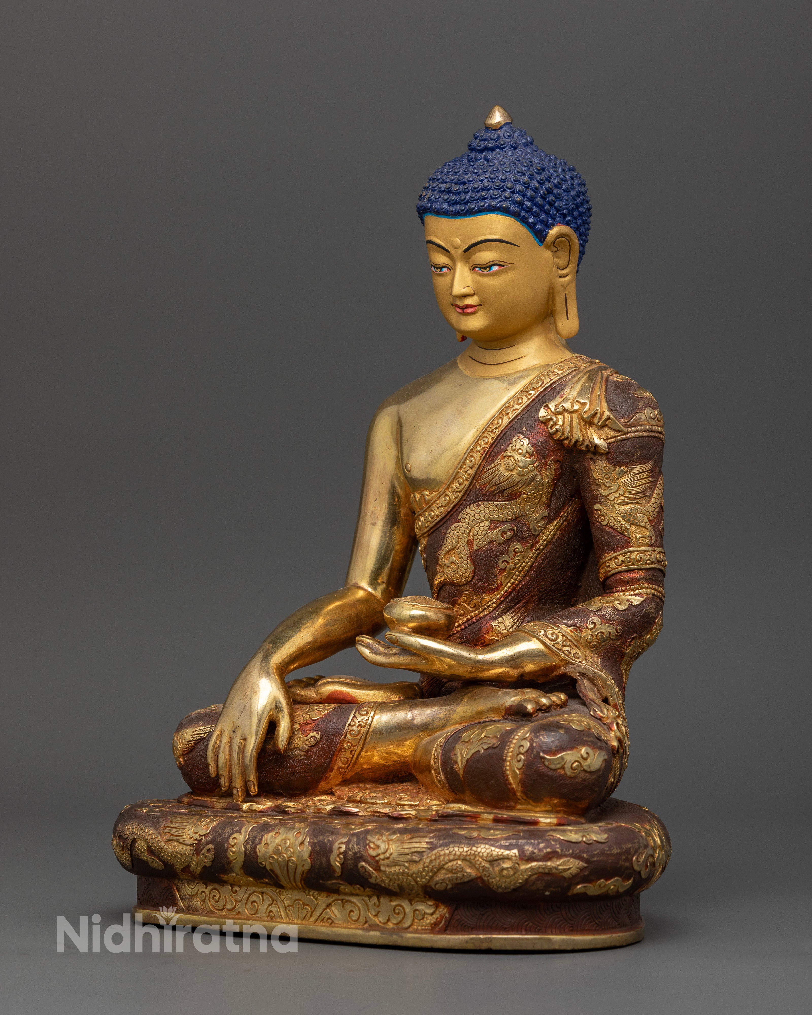 Shakyamuni Buddha statue seated on intricately carved Buddhist pedestal.