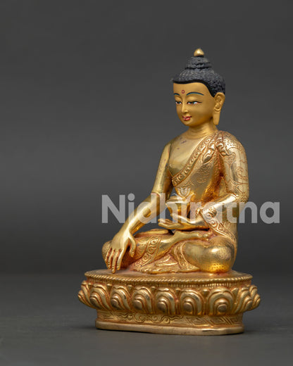 Shakyamuni Buddha statue showing earth-touching mudra and floral robe carving.
