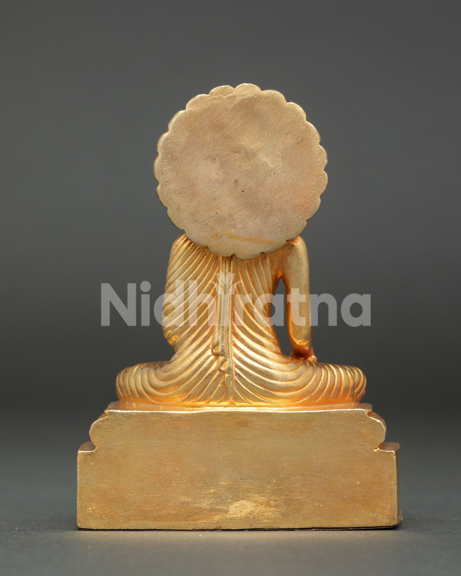 Shakyamuni buddha statue showing ornate throne gold gilded finish and traditional nepalese craftsmanship.