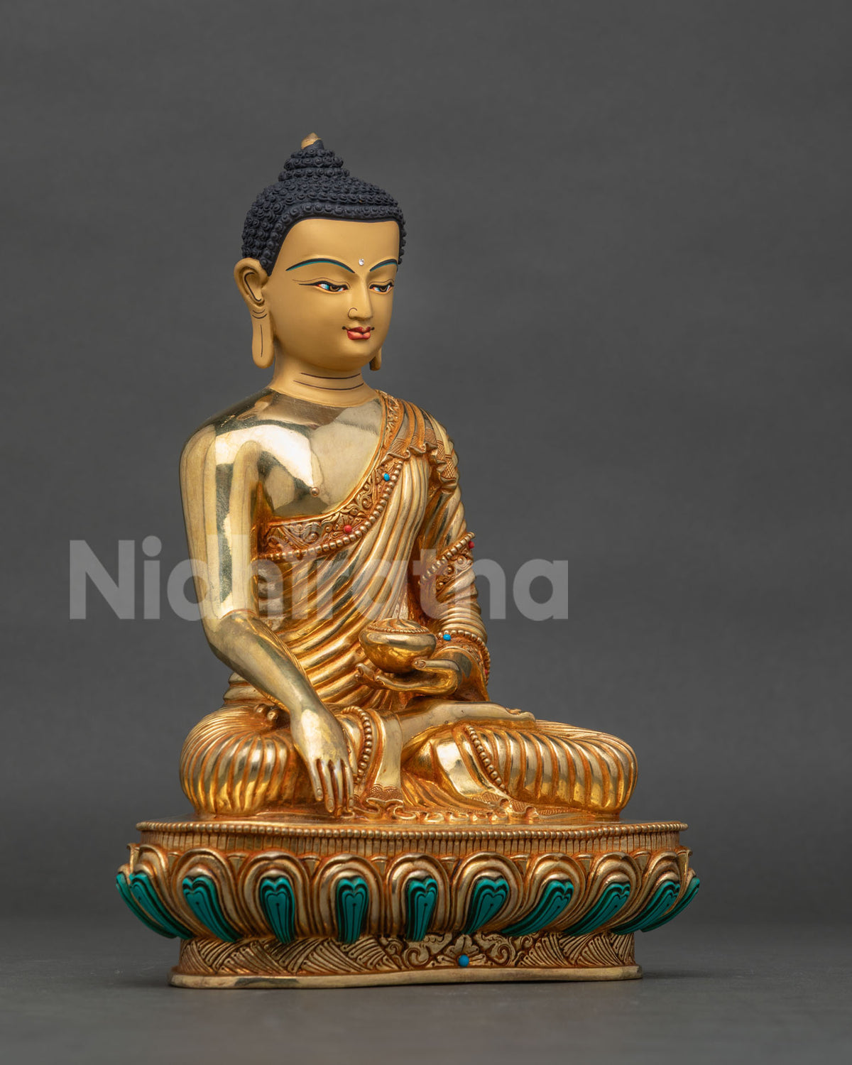 Shakyamuni Buddha statue side view hand carved lotus pedestal and robe.