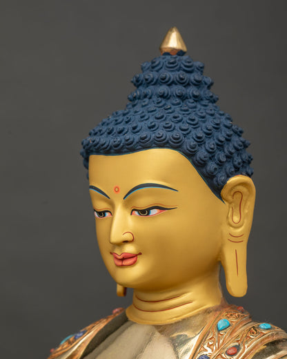 Shakyamuni Buddha statue turquoise coral lapis lazuli side face close up.