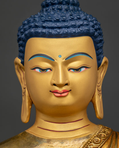 Shakyamuni Buddha statue with 24K gold painted face and blue eyes.