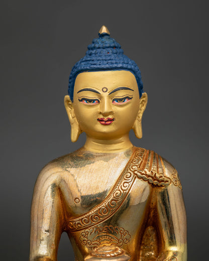 Shakyamuni Buddha statue with 24K gold painted face and floral robe details.