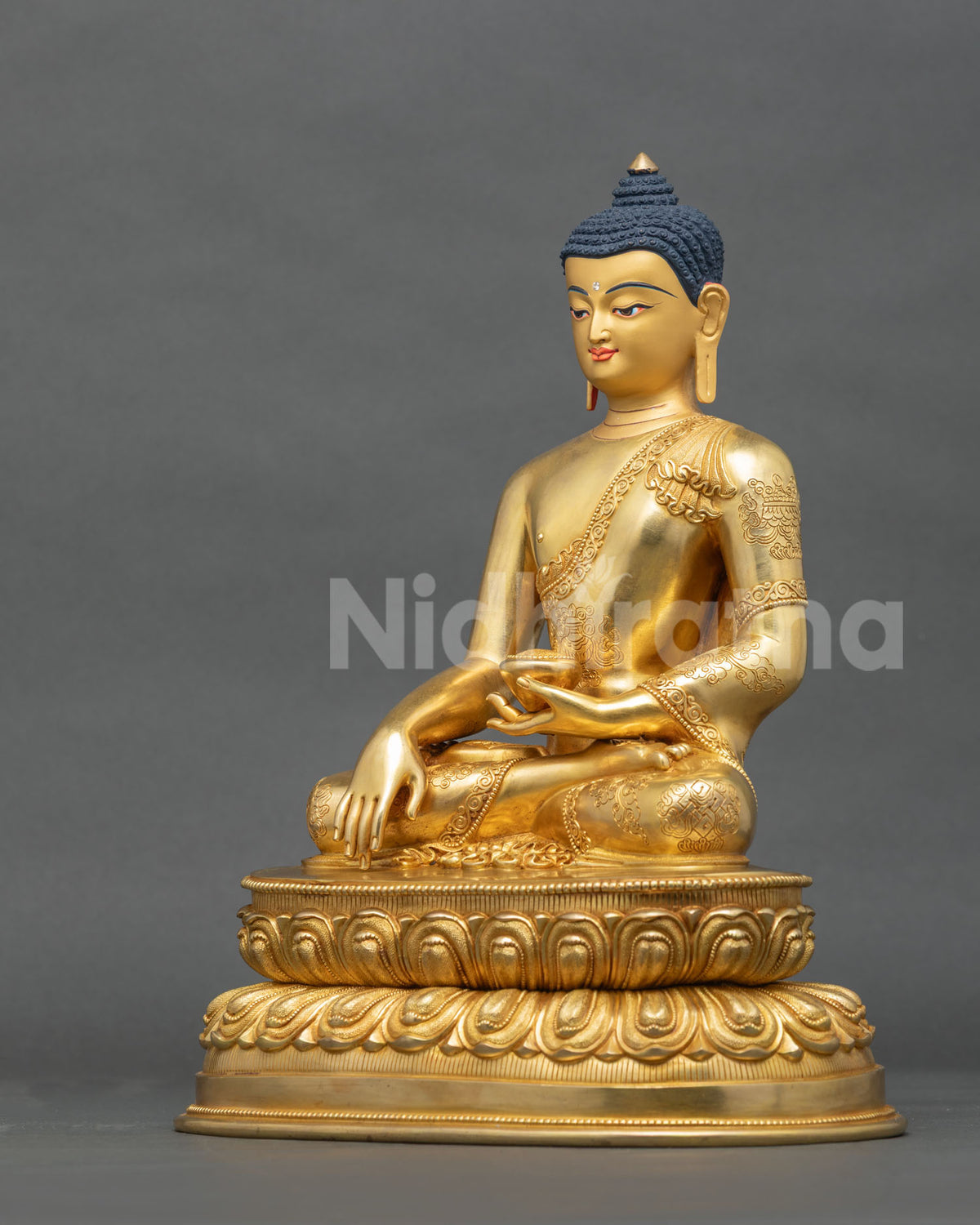 Shakyamuni Buddha statue with Bhumisparsha mudra and alms bowl left side view.