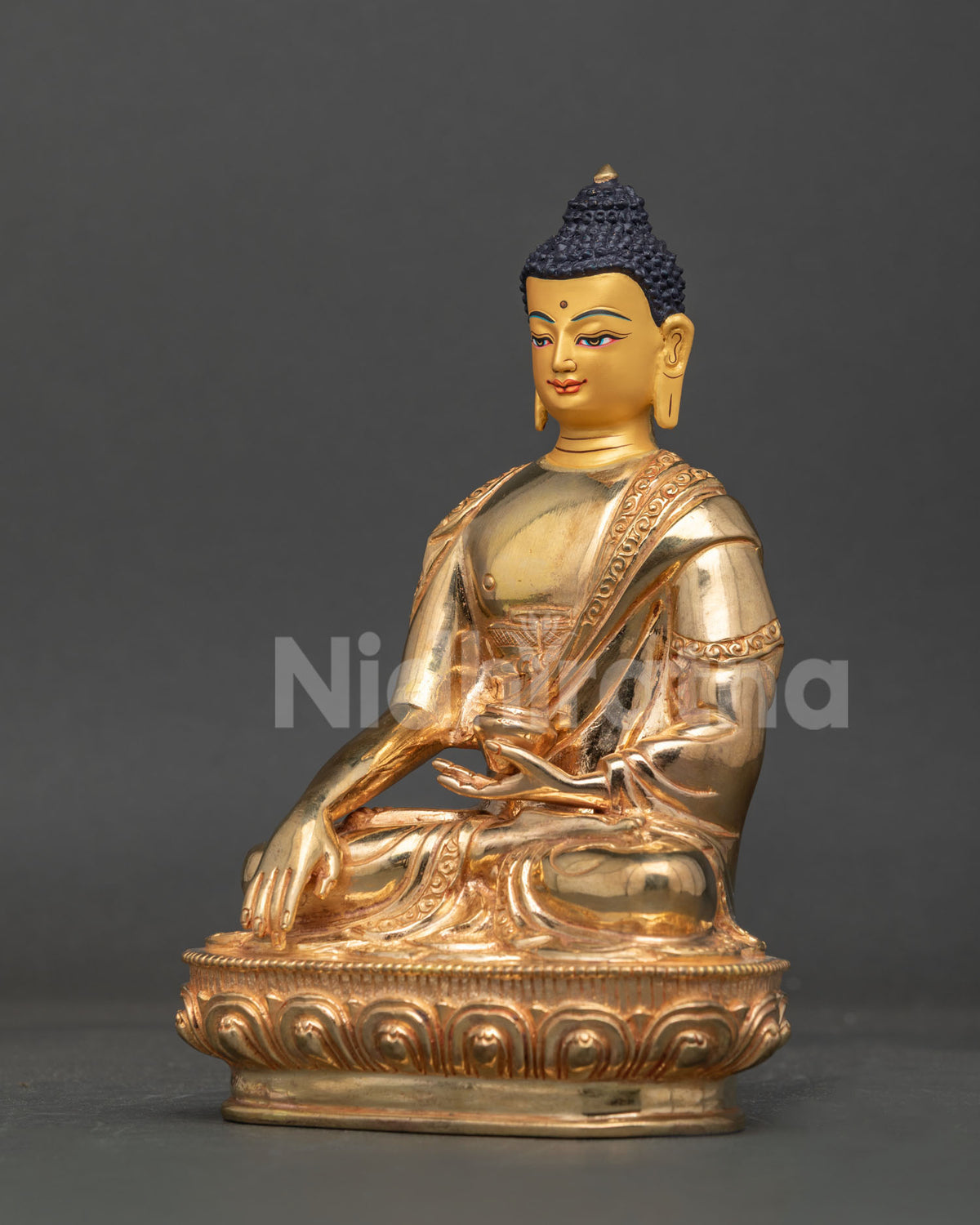 Shakyamuni buddha statue with delicate robe patterns and traditional carved motifs.